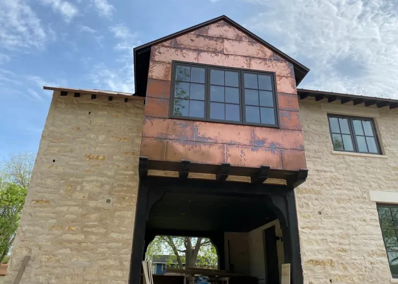 Copper metal panel facade on a stone building for Skylight Installation in Boerne